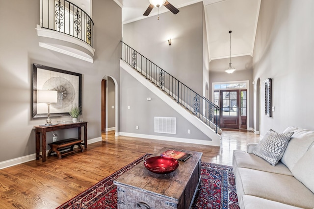 living room featuring a high ceiling and hardwood / wood-style floors