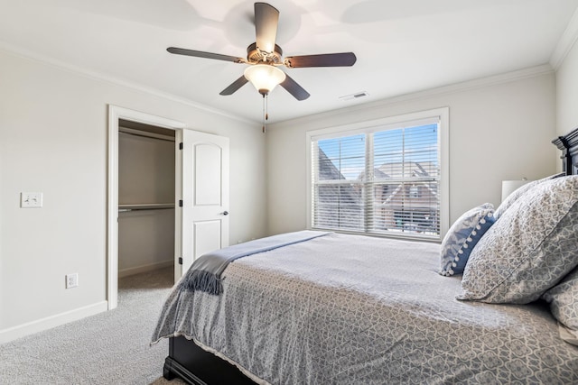 bedroom with carpet, ceiling fan, ornamental molding, and a closet