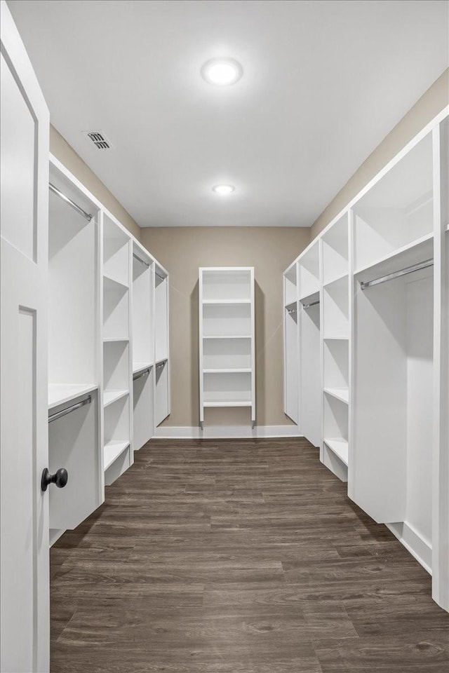 spacious closet featuring dark hardwood / wood-style flooring