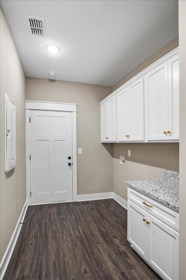 laundry area with dark wood-type flooring, cabinets, and washer hookup