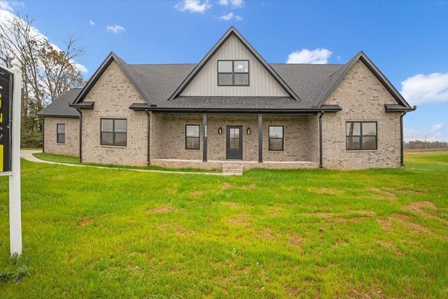 rear view of property featuring a lawn