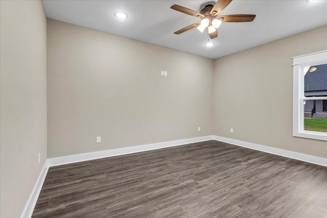 empty room featuring ceiling fan and dark wood-type flooring