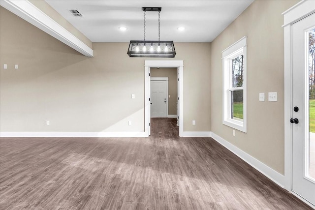 unfurnished dining area with dark hardwood / wood-style floors