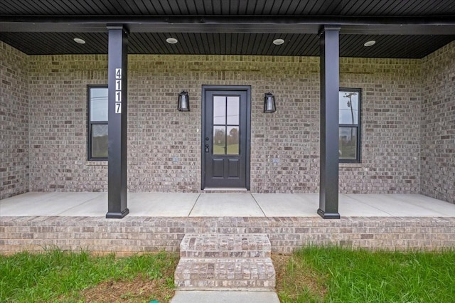 view of exterior entry featuring a porch