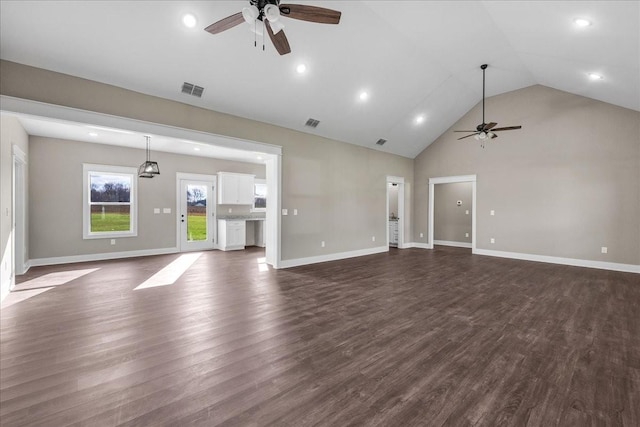 unfurnished living room with ceiling fan, high vaulted ceiling, and dark wood-type flooring