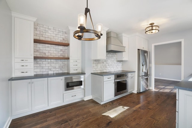 kitchen with dark wood-type flooring, stainless steel appliances, decorative backsplash, white cabinets, and custom exhaust hood