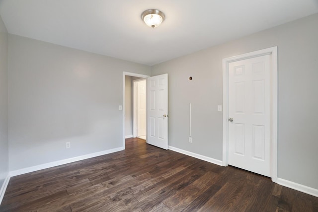 spare room with dark wood-type flooring