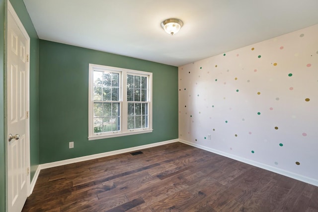 unfurnished room featuring dark hardwood / wood-style flooring