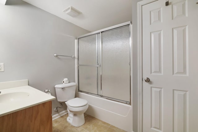 full bathroom with tile patterned floors, vanity, combined bath / shower with glass door, and toilet