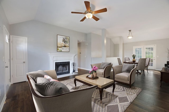 living room featuring dark hardwood / wood-style flooring, vaulted ceiling, and ceiling fan