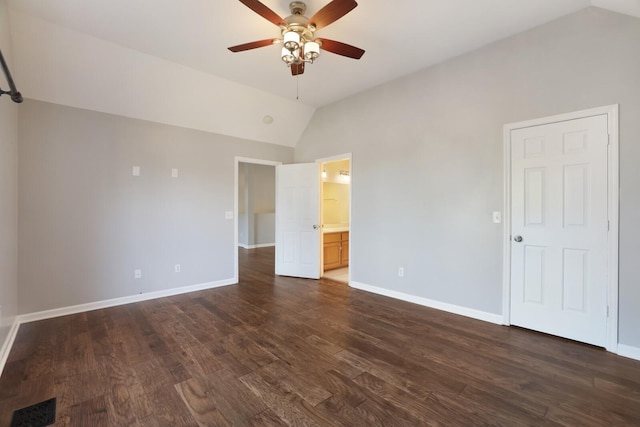 unfurnished bedroom with dark hardwood / wood-style flooring, ceiling fan, lofted ceiling, and connected bathroom