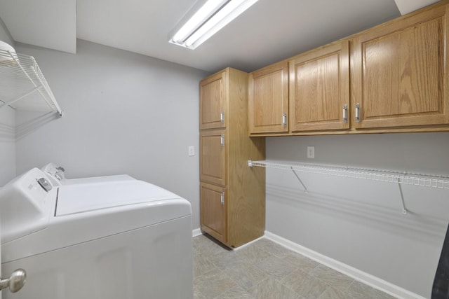 washroom with cabinets and washing machine and clothes dryer