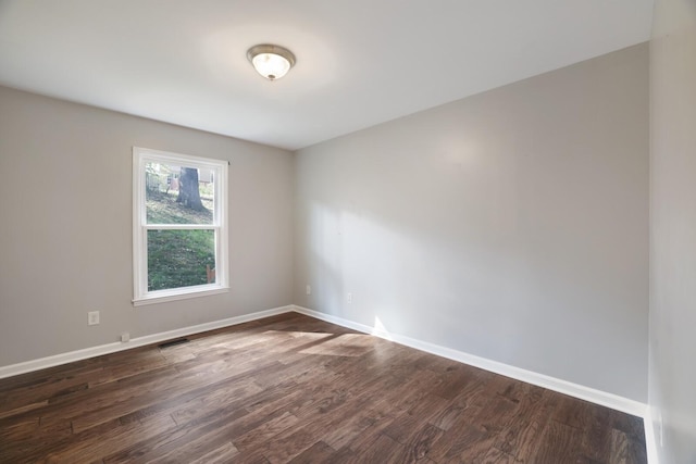 spare room with dark hardwood / wood-style floors