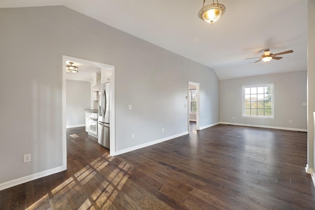 empty room with dark hardwood / wood-style floors, ceiling fan, and lofted ceiling