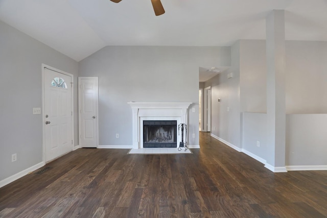 unfurnished living room with a tiled fireplace, ceiling fan, dark wood-type flooring, and lofted ceiling