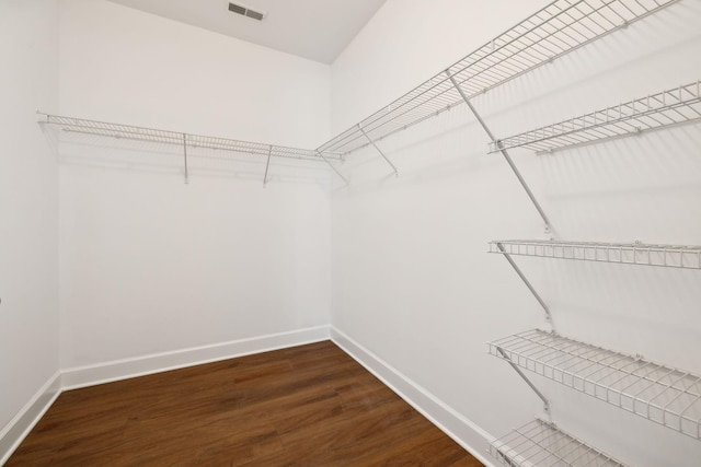 spacious closet with dark hardwood / wood-style floors