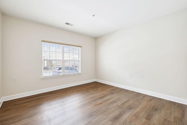 empty room with hardwood / wood-style floors