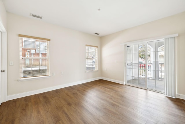 unfurnished room featuring hardwood / wood-style floors and a wealth of natural light