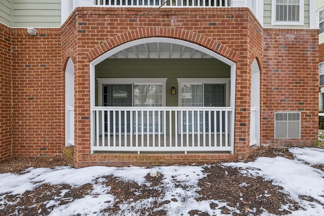 view of snow covered property entrance