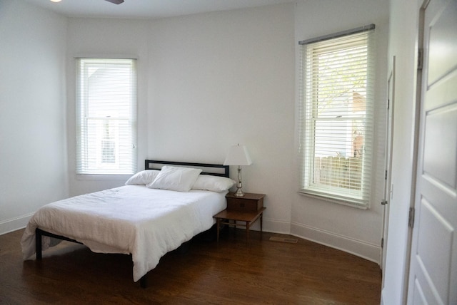 bedroom with ceiling fan and dark hardwood / wood-style floors