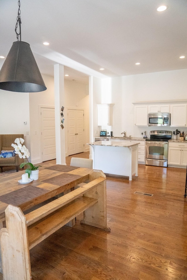 dining room featuring wood-type flooring and sink