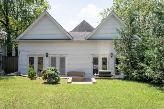 rear view of house with a yard and french doors