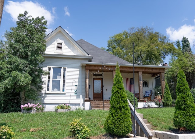 view of front of house with covered porch and a front yard