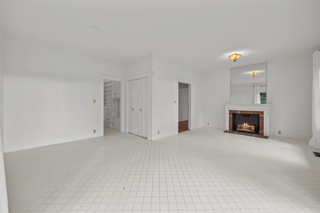 unfurnished living room featuring a fireplace