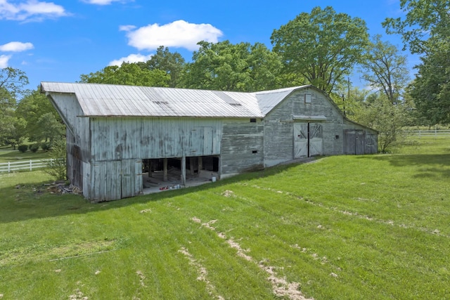 view of outbuilding featuring a yard