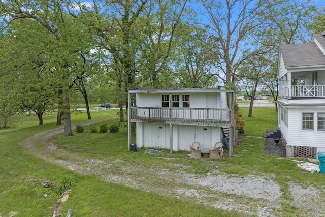 rear view of house featuring a lawn