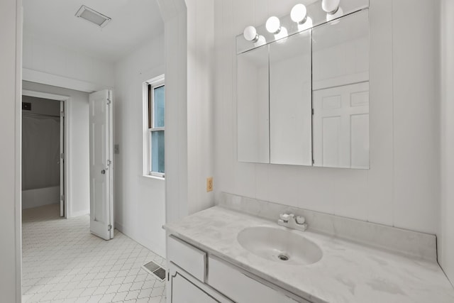 bathroom featuring tile patterned flooring and vanity