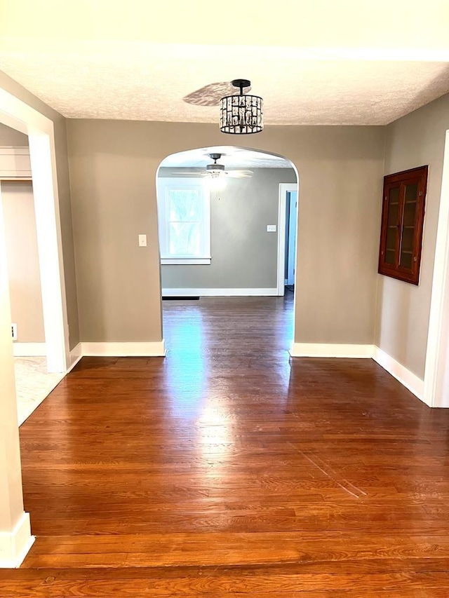 unfurnished dining area featuring hardwood / wood-style floors and ceiling fan