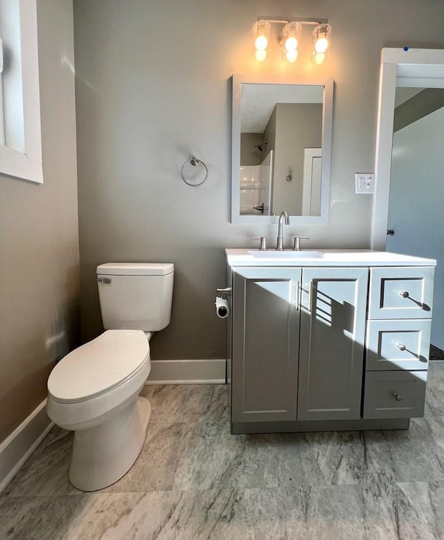 bathroom with vanity, toilet, and walk in shower