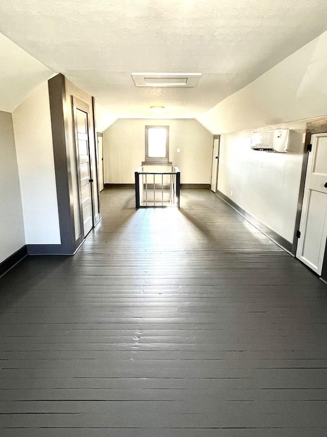 additional living space with dark hardwood / wood-style flooring and lofted ceiling