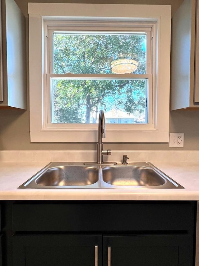 interior details with sink and white cabinets