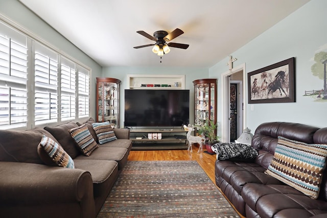 living room with ceiling fan and wood-type flooring