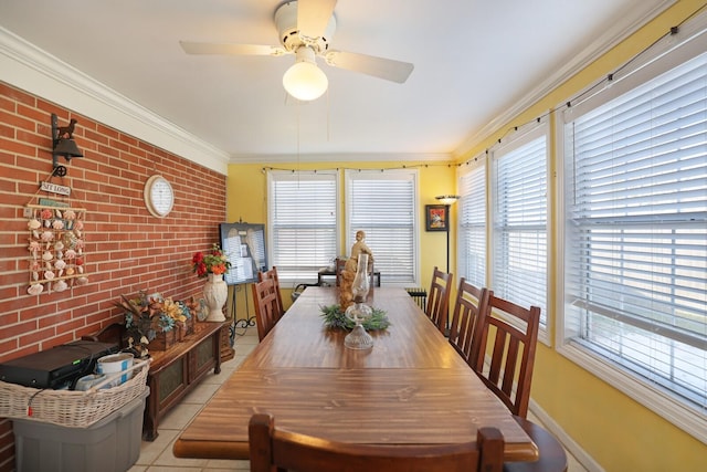 dining space with a healthy amount of sunlight, ornamental molding, and light tile patterned floors