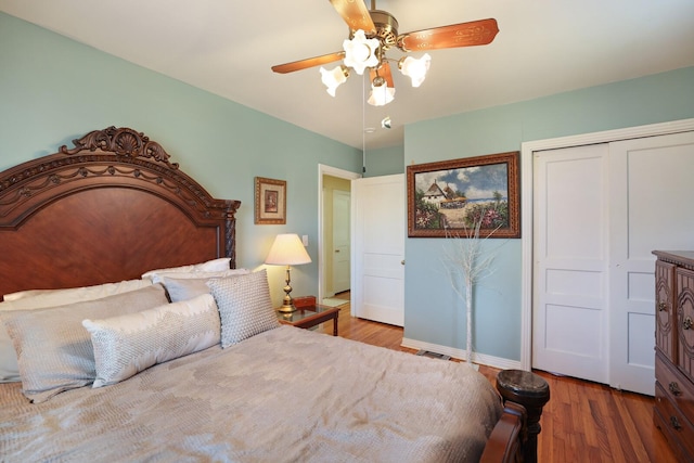 bedroom with ceiling fan, a closet, and hardwood / wood-style flooring