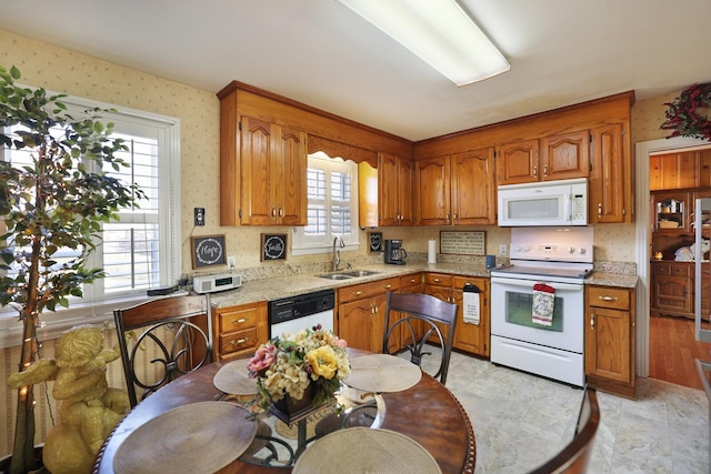 kitchen featuring white appliances and sink