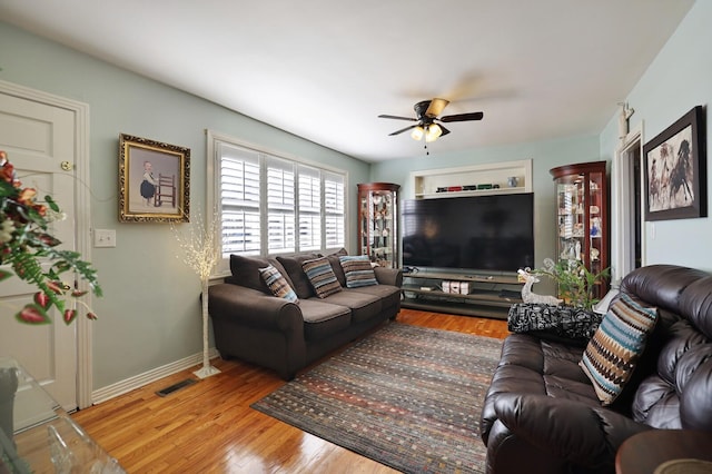 living room featuring ceiling fan and hardwood / wood-style flooring