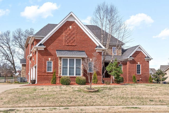 front of property featuring a garage, central air condition unit, and a front yard