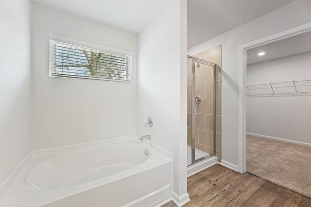 bathroom with plus walk in shower and wood-type flooring