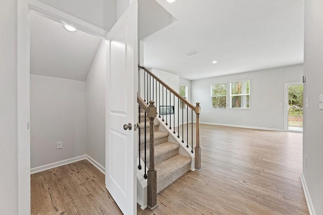 stairs with hardwood / wood-style flooring