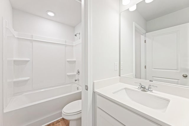 full bathroom with vanity, hardwood / wood-style floors, shower / bathing tub combination, and toilet