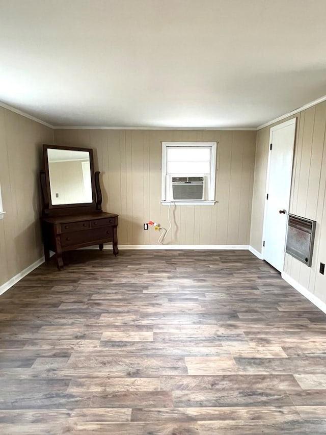 unfurnished living room featuring a fireplace, wood-type flooring, and heating unit