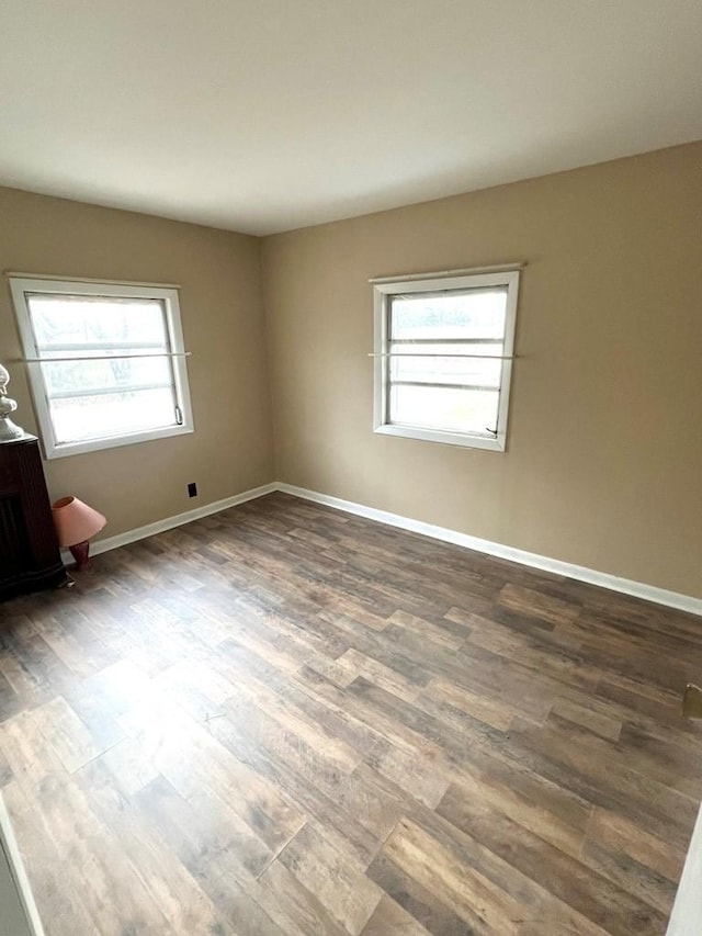 spare room with dark wood-type flooring