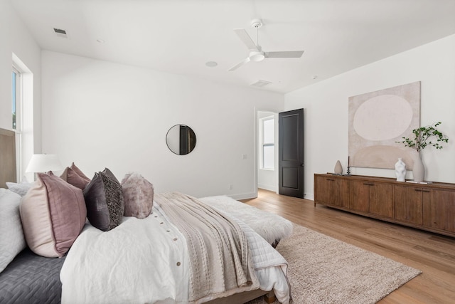 bedroom with light hardwood / wood-style flooring and ceiling fan