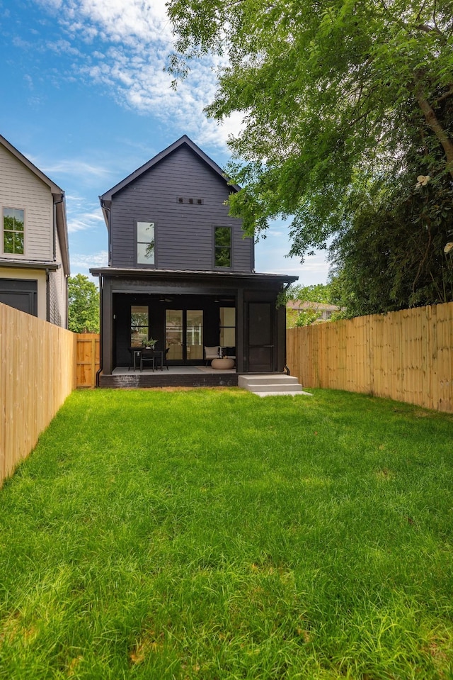 back of house with a lawn