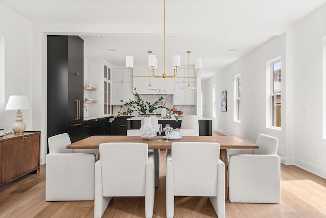 dining space featuring a chandelier and light hardwood / wood-style flooring