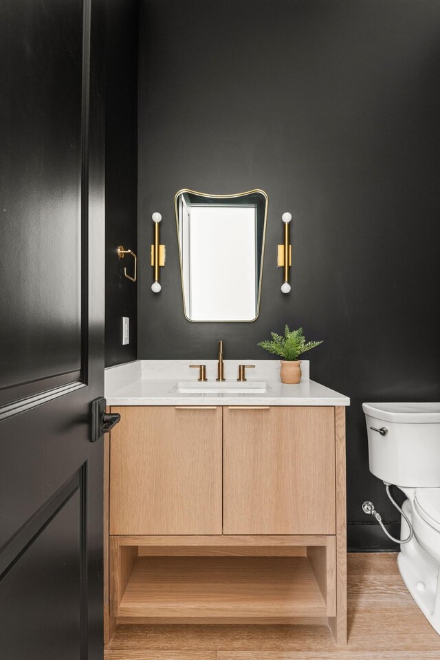 bathroom featuring vanity and toilet